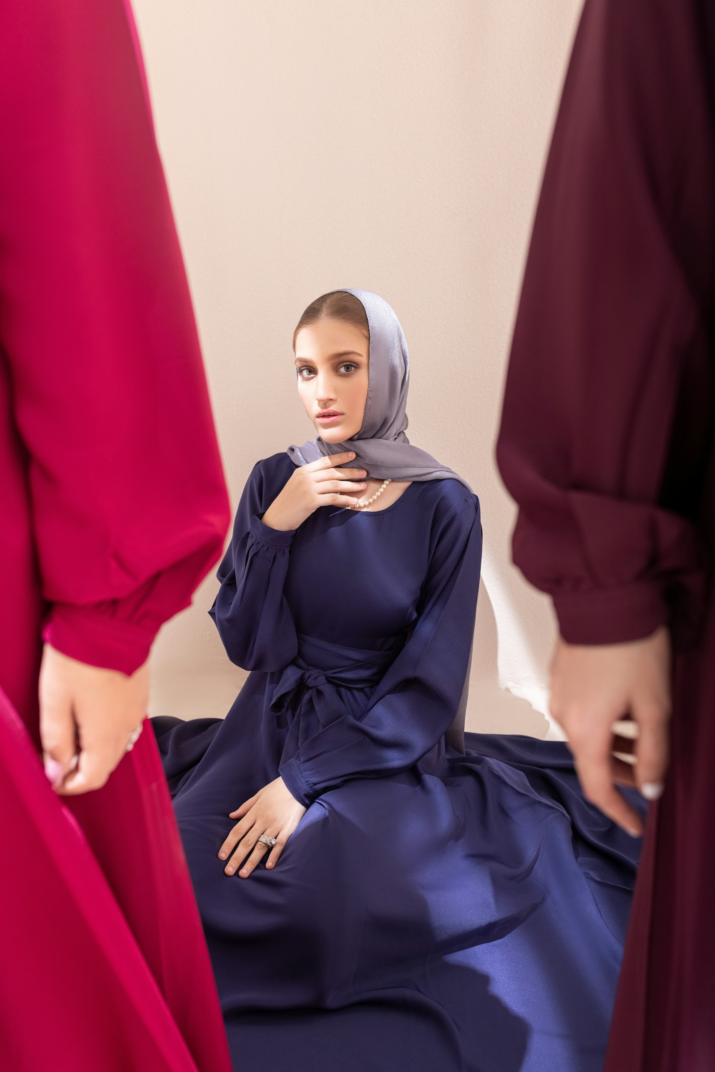 Model wearing a navy abaya with a grey hijab